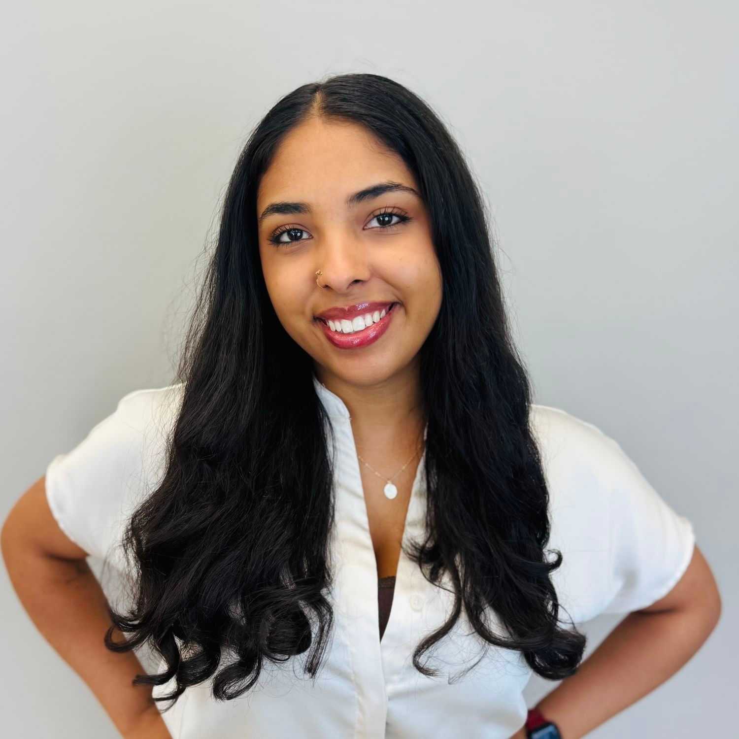 Portrait of Jeneva Marcano, a professional stylist at Tommy's Salon, showcasing their expertise and style.