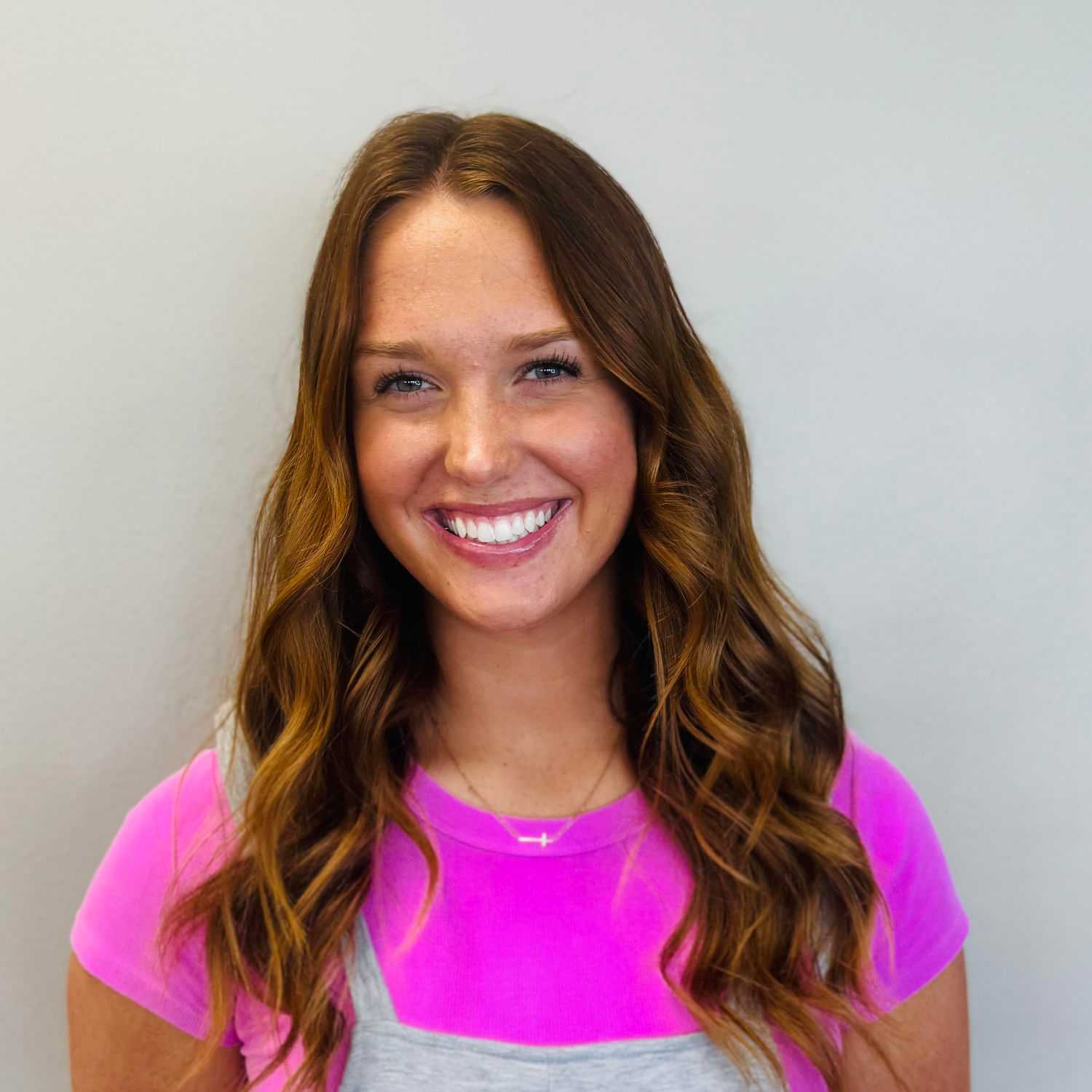 Portrait of Katie Strotman, a professional stylist at Tommy's Salon, showcasing their expertise and style.