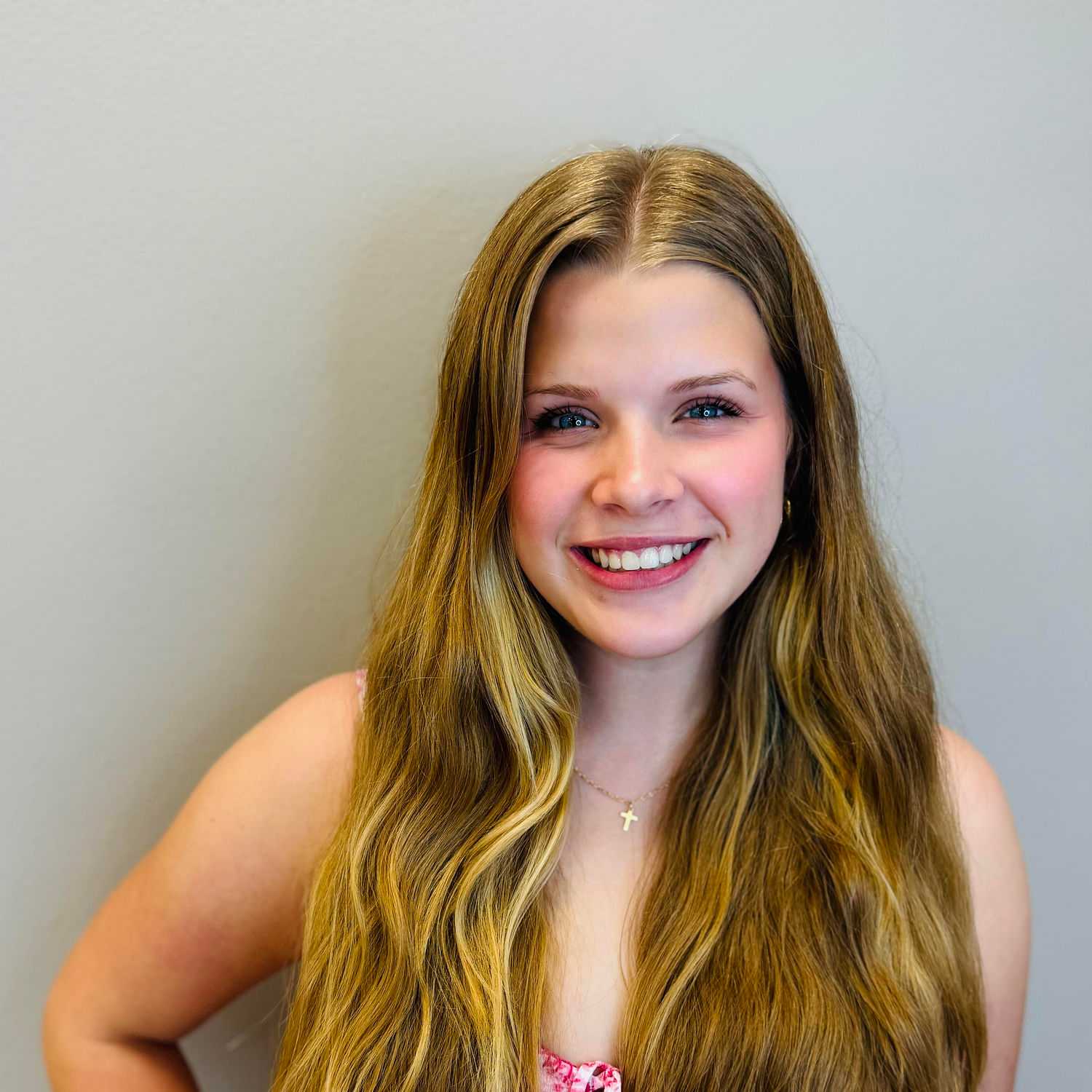 Portrait of Ireland Doyle, a professional stylist at Tommy's Salon, showcasing their expertise and style.
