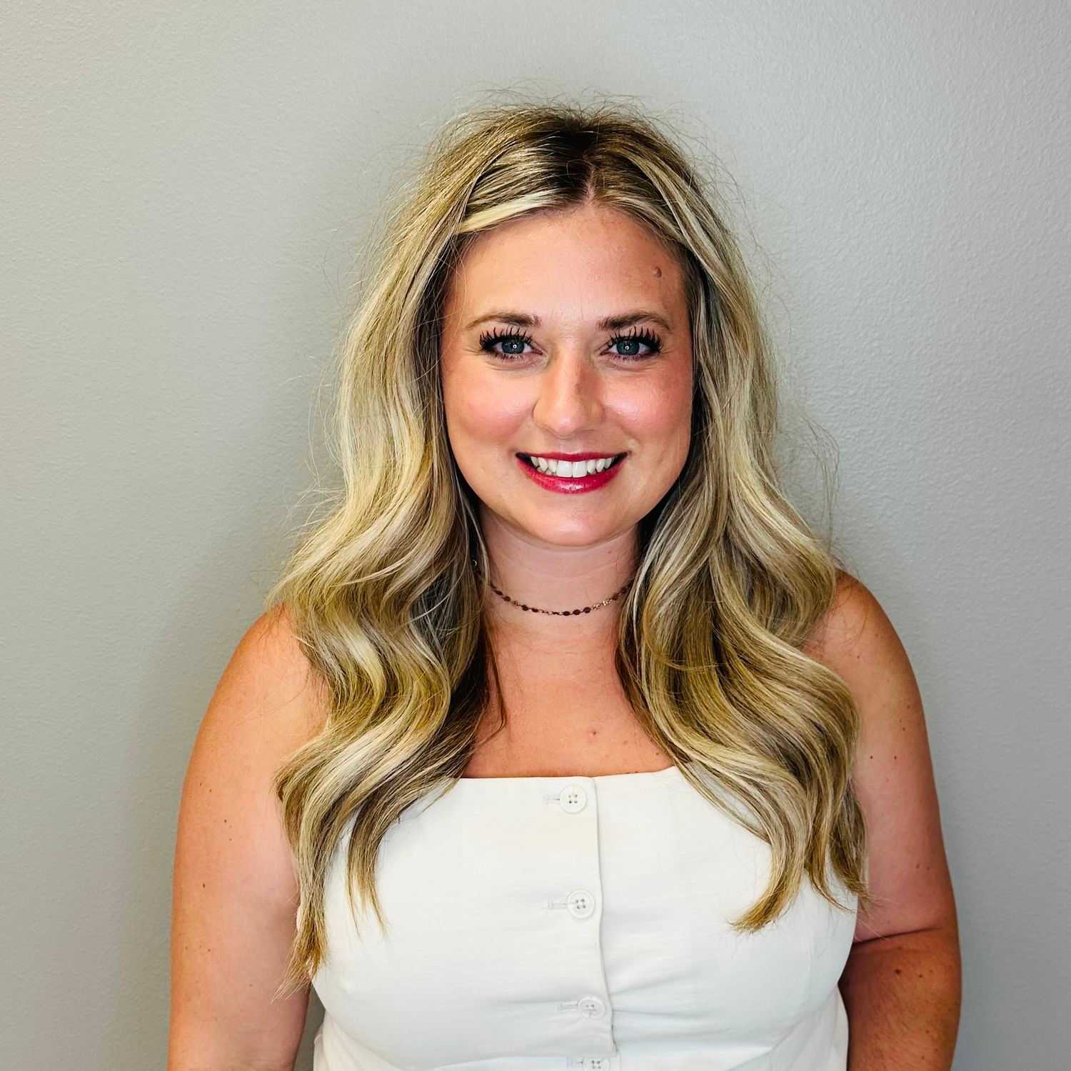 Portrait of Jessie Bartz, a professional stylist at Tommy's Salon, showcasing their expertise and style.